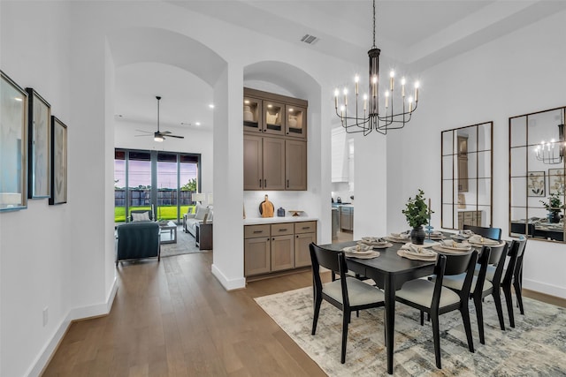 6826 Mirabeau Ln, Katy, TX 77493 - dining area with a chandelier, a ceiling fan, hardwood / wood-style flooring, arched walkways, and recessed lighting