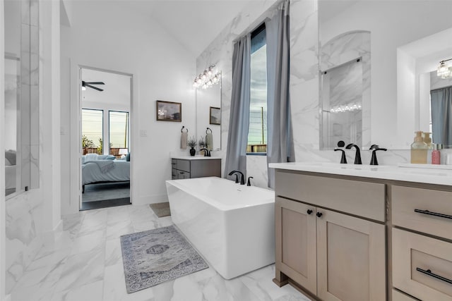 6826 Mirabeau Ln, Katy, TX 77493 - full bath featuring ensuite bathroom, marble finish floors, a freestanding tub, lofted ceiling, and two vanities