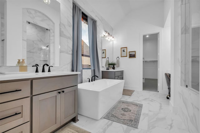 6826 Mirabeau Ln, Katy, TX 77493 - full bathroom with a walk in closet, lofted ceiling, two vanities, a freestanding bath, and marble finish flooring