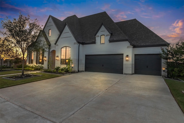 6826 Mirabeau Ln, Katy, TX 77493 - french provincial home with concrete driveway, roof with shingles, and a garage