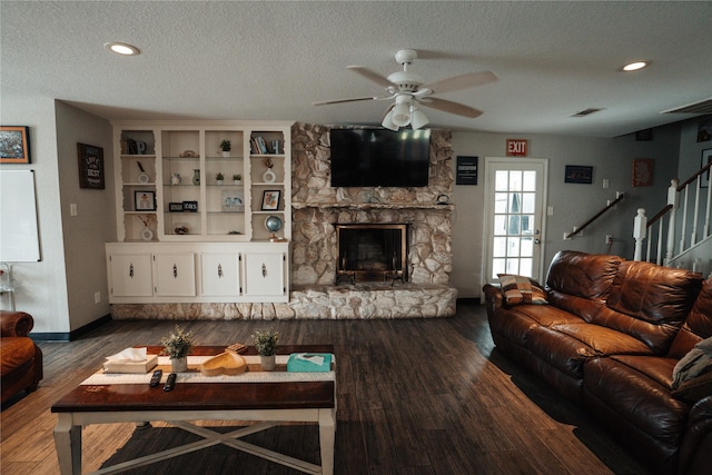 8432 Park Place Blvd, Houston, TX 77017 - living room with a textured ceiling, a ceiling fan, dark wood-style flooring, a fireplace, and stairs