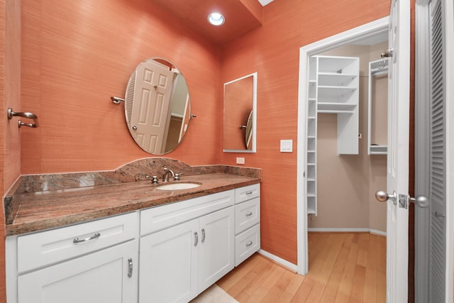 1111 Bering Dr Unit 306, Houston, TX 77057 - bathroom featuring vanity, wood finished floors, and a spacious closet