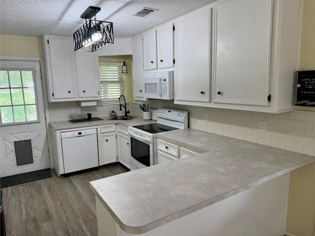 344 Timber Bay Dr, Trinity, TX 75862 - kitchen with white appliances, dark wood-style flooring, healthy amount of natural light, light countertops, and a textured ceiling