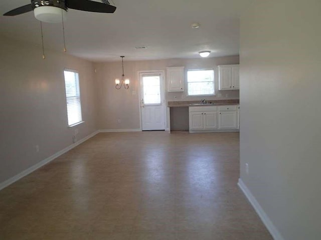 6906 Lost Timber Ln, Richmond, TX 77469 - unfurnished living room featuring a chandelier, a ceiling fan, and light flooring