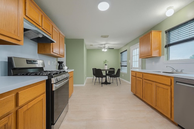 10834 Glenora Dr, Houston, TX 77065 - kitchen with appliances with stainless steel finishes, under cabinet range hood, a ceiling fan, and light countertops