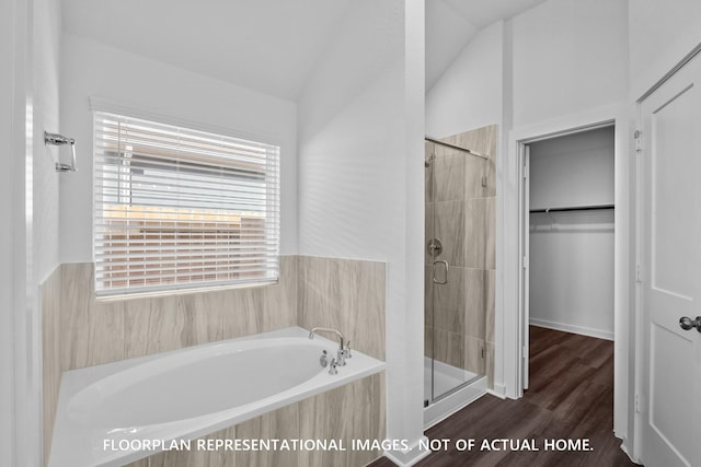 26112 Ethereal Rd, La Marque, TX 77563 - bathroom featuring a shower stall, a bath, a spacious closet, wood finished floors, and vaulted ceiling