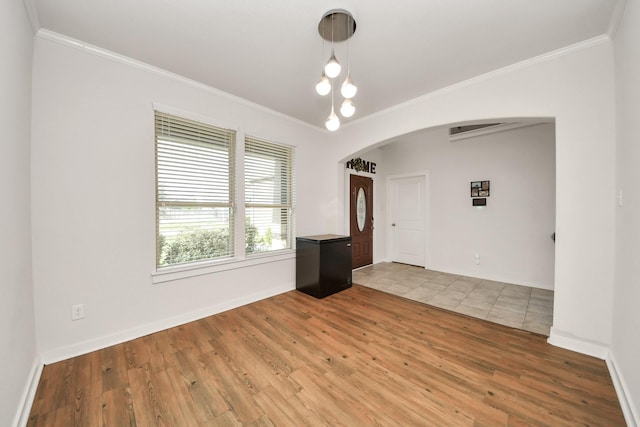 622 Aberhill Dr, Rosharon, TX 77583 - unfurnished room featuring arched walkways, ornamental molding, and wood finished floors