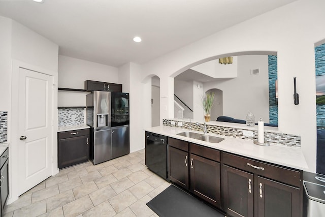 622 Aberhill Dr, Rosharon, TX 77583 - kitchen featuring stainless steel fridge with ice dispenser, black dishwasher, arched walkways, backsplash, and light countertops