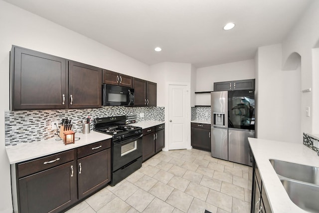622 Aberhill Dr, Rosharon, TX 77583 - kitchen with black appliances, light countertops, decorative backsplash, dark brown cabinetry, and light tile patterned floors