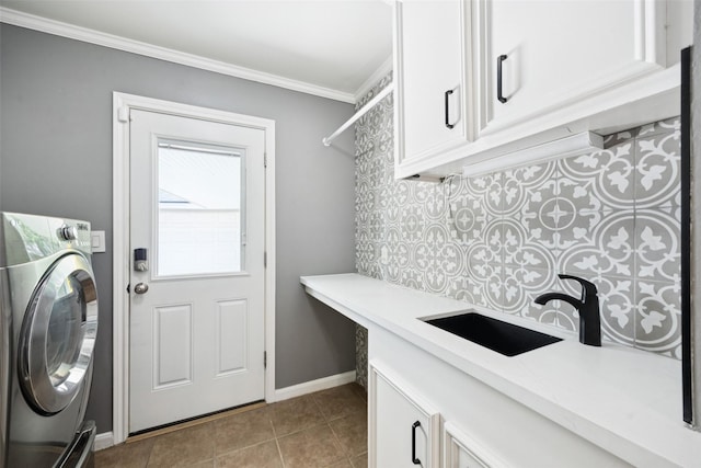 10610 Bordley Dr, Houston, TX 77042 - laundry room with washer / dryer, cabinet space, crown molding, and light tile patterned floors