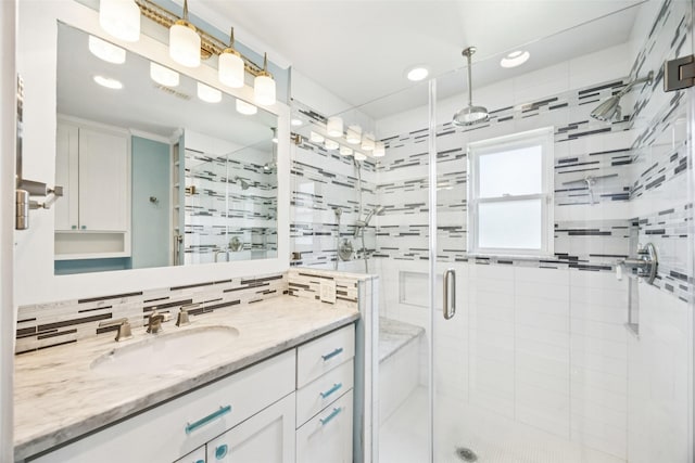 10610 Bordley Dr, Houston, TX 77042 - full bathroom featuring vanity, a shower stall, recessed lighting, and decorative backsplash