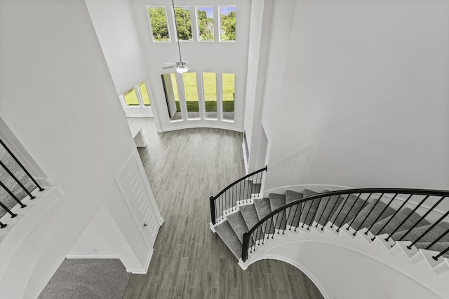 5029 Steady Breeze Dr, Katy, TX 77493 - staircase with a towering ceiling, ceiling fan, and wood finished floors