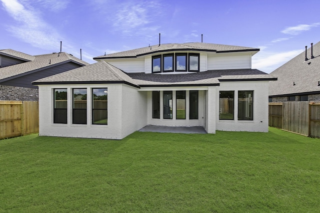 5029 Steady Breeze Dr, Katy, TX 77493 - rear view of house featuring a fenced backyard, a shingled roof, and brick siding