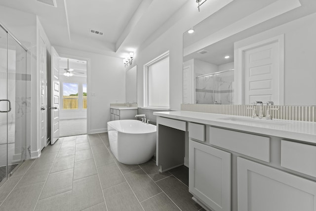 5029 Steady Breeze Dr, Katy, TX 77493 - full bathroom with two vanities, a marble finish shower, a freestanding tub, ceiling fan, and recessed lighting