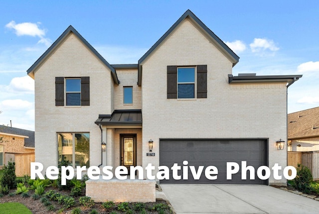 5029 Steady Breeze Dr, Katy, TX 77493 - view of front facade with an attached garage, driveway, brick siding, and a standing seam roof