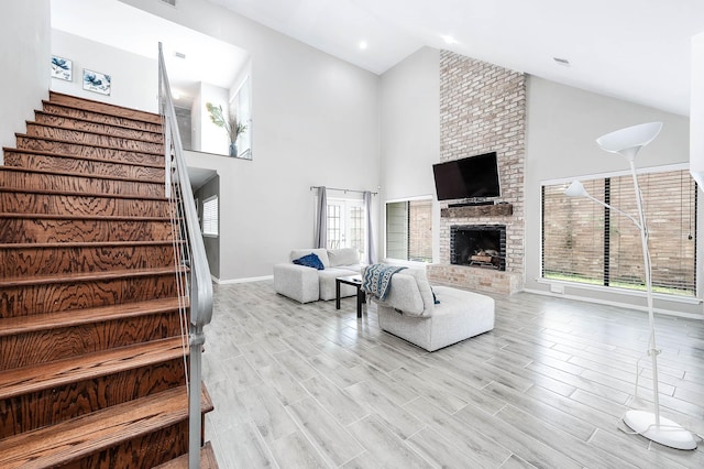12710 Ashford Pine Dr, Houston, TX 77082 - living room with high vaulted ceiling, stairway, wood finished floors, and a fireplace