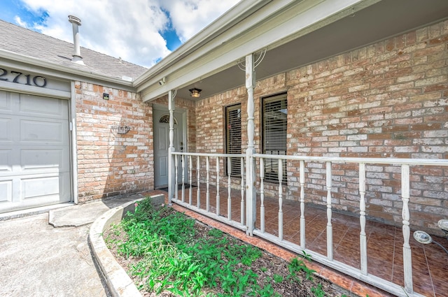 12710 Ashford Pine Dr, Houston, TX 77082 - doorway to property with brick siding, covered porch, a shingled roof, and a garage