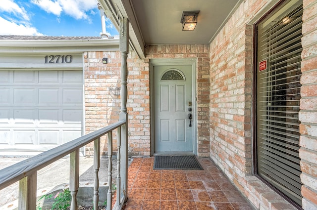 12710 Ashford Pine Dr, Houston, TX 77082 - doorway to property featuring brick siding and covered porch