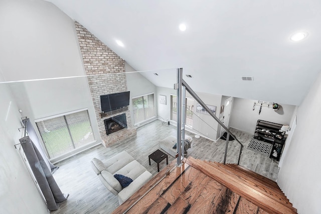 12710 Ashford Pine Dr, Houston, TX 77082 - living room featuring vaulted ceiling, wood finished floors, a fireplace, and recessed lighting
