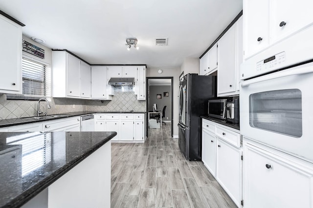 12710 Ashford Pine Dr, Houston, TX 77082 - kitchen with appliances with stainless steel finishes, white cabinets, backsplash, and dark stone countertops