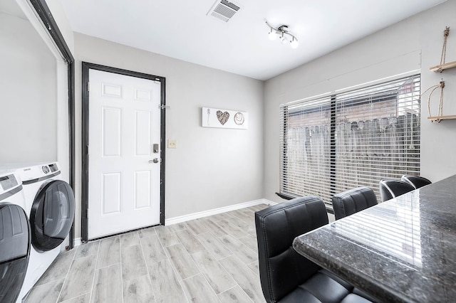 12710 Ashford Pine Dr, Houston, TX 77082 - dining space with washing machine and dryer and wood finished floors