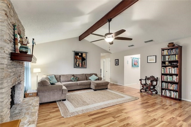 600 Erin Cir, Leander, TX 78641 - living area featuring light wood finished floors, ceiling fan, and a fireplace