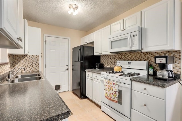 600 Erin Cir, Leander, TX 78641 - kitchen featuring white appliances, white cabinets, a textured ceiling, and dark countertops