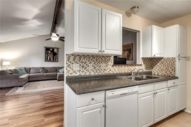 600 Erin Cir, Leander, TX 78641 - kitchen with white dishwasher, dark countertops, white cabinets, backsplash, and a textured ceiling