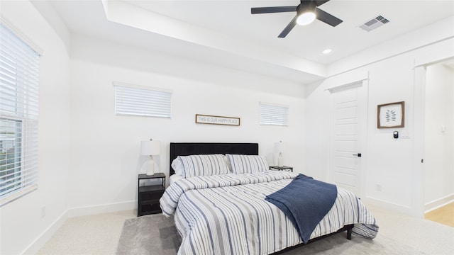 2712 Jensen Creek Ln, Houston, TX 77026 - bedroom with multiple windows, light carpet, ceiling fan, and recessed lighting