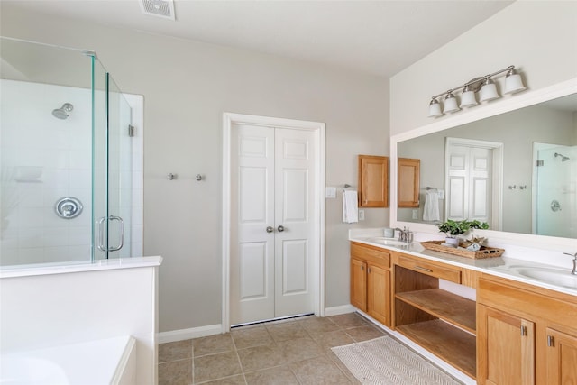 19002 Volley Vale Ct, Humble, TX 77346 - bathroom featuring a shower stall, double vanity, tile patterned floors, and a tub to relax in