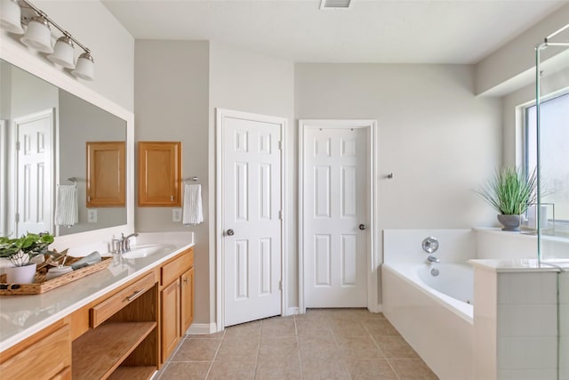 19002 Volley Vale Ct, Humble, TX 77346 - bathroom featuring vanity, a bath, and tile patterned floors