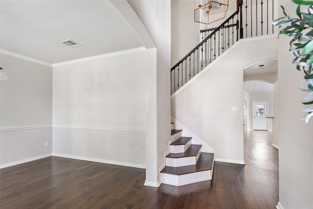 19002 Volley Vale Ct, Humble, TX 77346 - stairway featuring arched walkways, wood finished floors, and ornamental molding