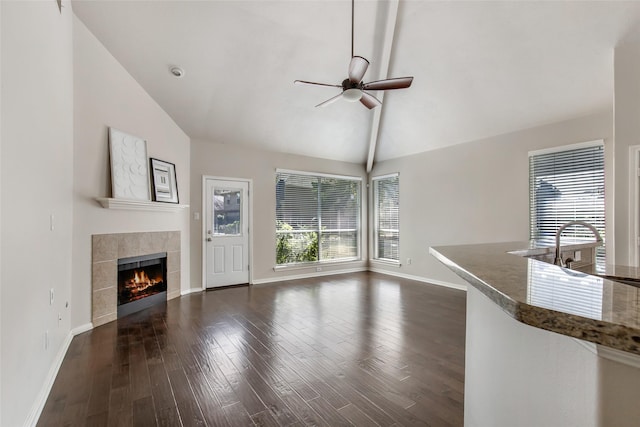 19002 Volley Vale Ct, Humble, TX 77346 - unfurnished living room with a ceiling fan, a fireplace, dark wood-style flooring, and high vaulted ceiling