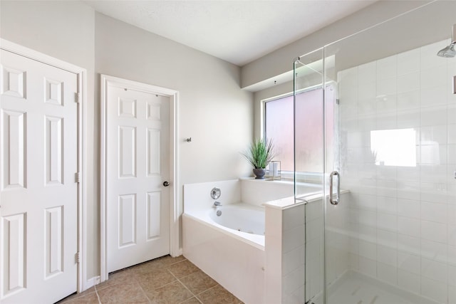 19002 Volley Vale Ct, Humble, TX 77346 - bathroom featuring a bath, a shower stall, and tile patterned floors