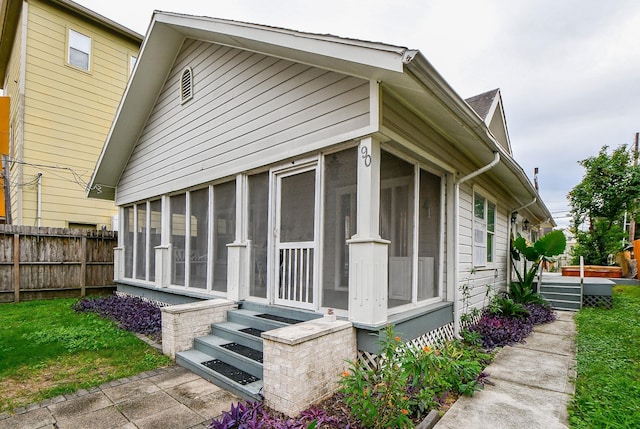 90 Dennis St, Houston, TX 77006 - view of side of home featuring a sunroom and entry steps