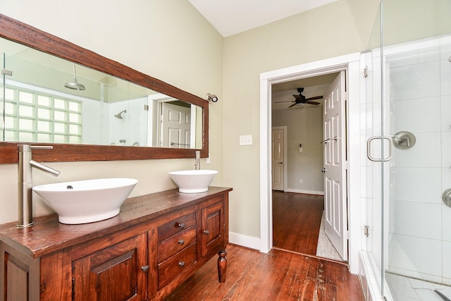 90 Dennis St, Houston, TX 77006 - bathroom featuring double vanity, a stall shower, wood finished floors, and a ceiling fan