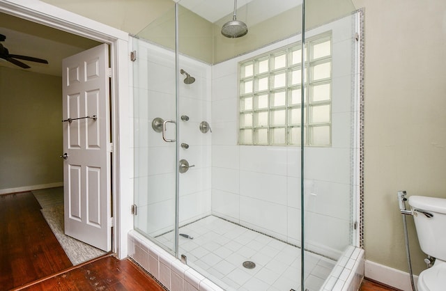 90 Dennis St, Houston, TX 77006 - bathroom featuring a shower stall, wood finished floors, and a ceiling fan