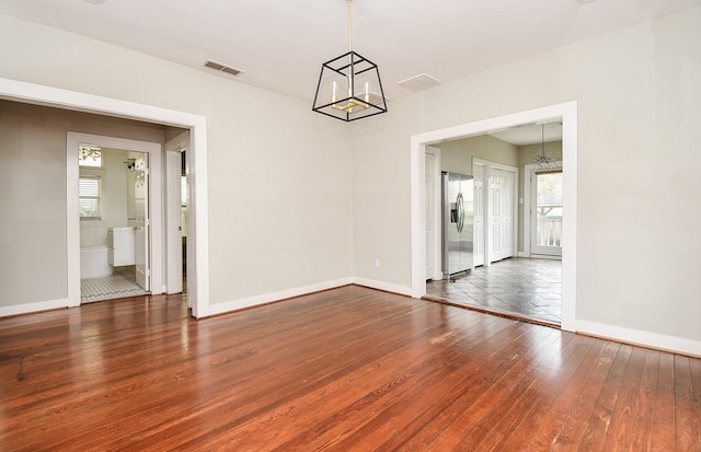 90 Dennis St, Houston, TX 77006 - unfurnished room with a chandelier and wood-type flooring