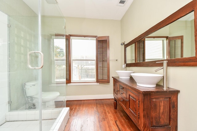 90 Dennis St, Houston, TX 77006 - bathroom with hardwood / wood-style flooring, double vanity, and a stall shower