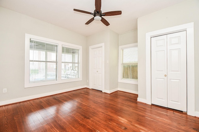 90 Dennis St, Houston, TX 77006 - unfurnished bedroom featuring multiple closets, hardwood / wood-style floors, and a ceiling fan