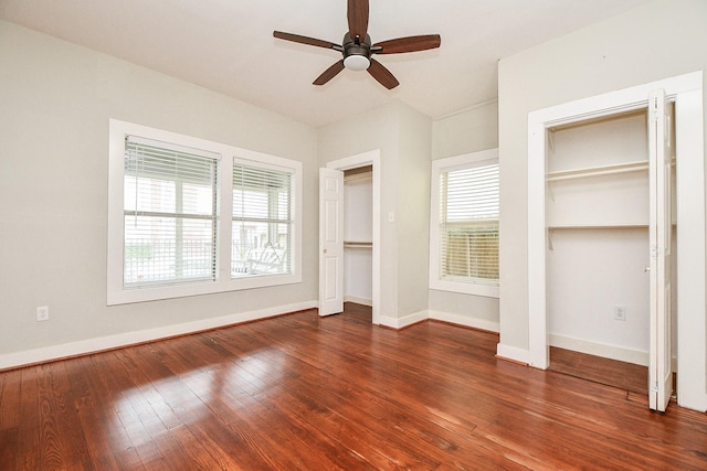 90 Dennis St, Houston, TX 77006 - unfurnished bedroom featuring two closets, wood-type flooring, and a ceiling fan