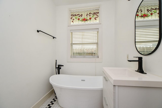 90 Dennis St, Houston, TX 77006 - full bath featuring vanity, a freestanding tub, and tile patterned floors