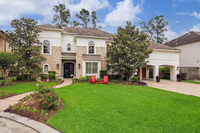 2 Burkhart Forest Ct, Spring Valley Village, TX 77055 - view of front of property with a front lawn, concrete driveway, stone siding, a standing seam roof, and a metal roof