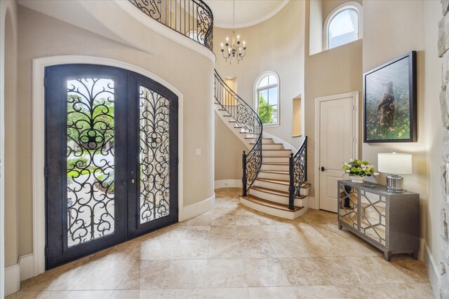2 Burkhart Forest Ct, Spring Valley Village, TX 77055 - foyer featuring french doors, healthy amount of natural light, a high ceiling, stairway, and a chandelier