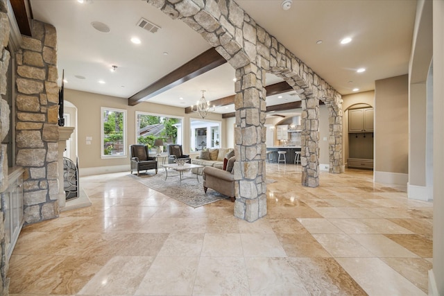 2 Burkhart Forest Ct, Spring Valley Village, TX 77055 - living room with arched walkways, decorative columns, a stone fireplace, a chandelier, and recessed lighting