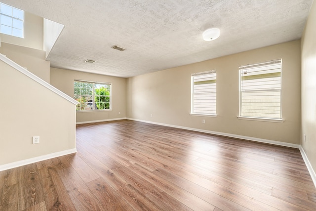 3434 Fiorella Way, Humble, TX 77338 - spare room with a textured ceiling, hardwood / wood-style flooring, and stairs