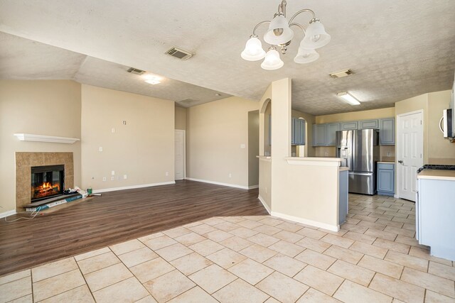3434 Fiorella Way, Humble, TX 77338 - kitchen with stainless steel appliances, a chandelier, light countertops, open floor plan, and light wood-type flooring