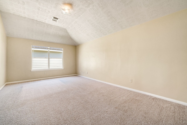 3434 Fiorella Way, Humble, TX 77338 - unfurnished room with carpet, vaulted ceiling, and a textured ceiling