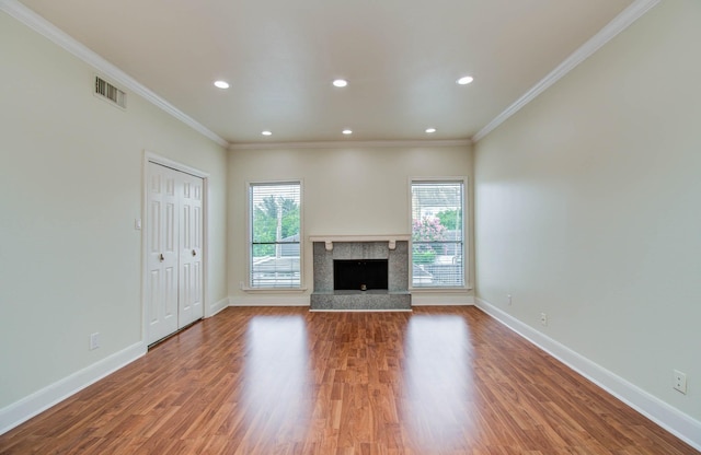 5701 Winsome Ln Unit 2, Houston, TX 77057 - unfurnished living room with ornamental molding, wood finished floors, a fireplace with raised hearth, and recessed lighting