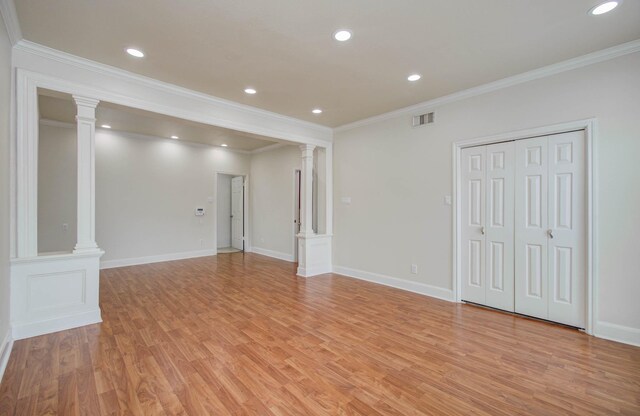5701 Winsome Ln Unit 2, Houston, TX 77057 - unfurnished living room featuring ornate columns, light wood finished floors, crown molding, and recessed lighting